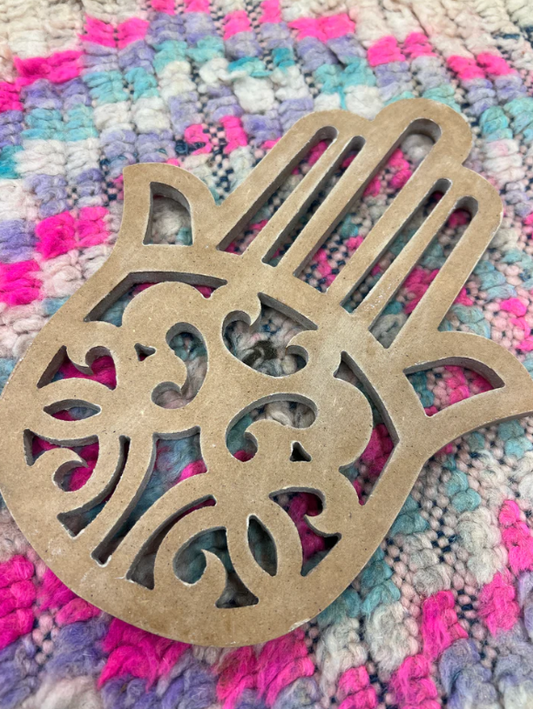 Detail van de handgemaakte Hamsa wanddecoratie met verfijnde uitsnijdingen, een spiritueel interieurstatement.